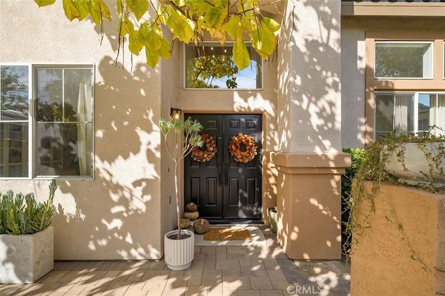 property entrance featuring stucco siding