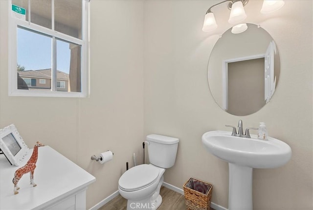 10969 Elkwood Cir, Riverside, CA 92503 - half bath featuring toilet, baseboards, wood finished floors, and a sink