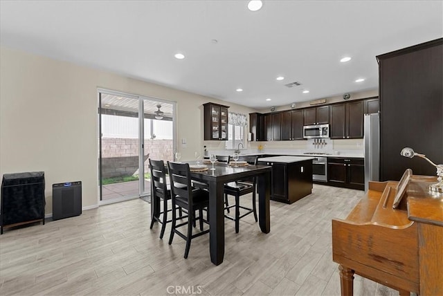 10969 Elkwood Cir, Riverside, CA 92503 - dining room with light wood finished floors, recessed lighting, and baseboards
