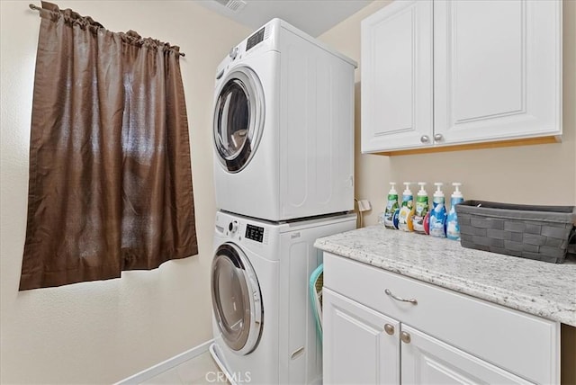 10969 Elkwood Cir, Riverside, CA 92503 - clothes washing area with stacked washer and clothes dryer and cabinet space