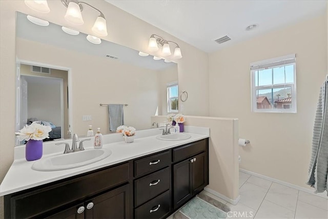 10969 Elkwood Cir, Riverside, CA 92503 - ensuite bathroom featuring double vanity, toilet, baseboards, and marble finish floors