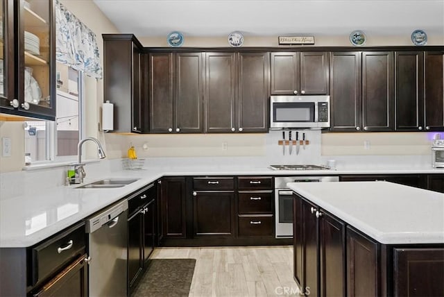 10969 Elkwood Cir, Riverside, CA 92503 - kitchen featuring stainless steel appliances, a sink, light countertops, and dark brown cabinets
