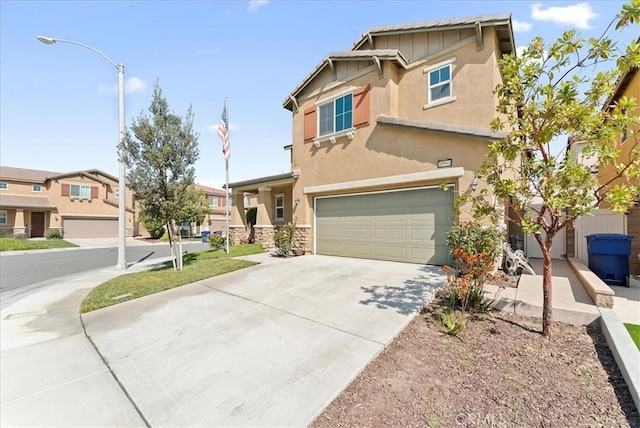 10969 Elkwood Cir, Riverside, CA 92503 - view of front facade featuring an attached garage, concrete driveway, stucco siding, stone siding, and board and batten siding