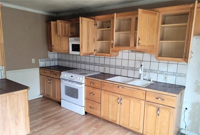 kitchen featuring crown molding, open shelves, a sink, white appliances, and light wood-style flooring