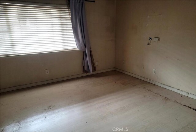 spare room featuring baseboards