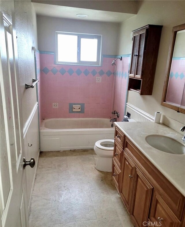 full bathroom featuring tub / shower combination, vanity, and toilet