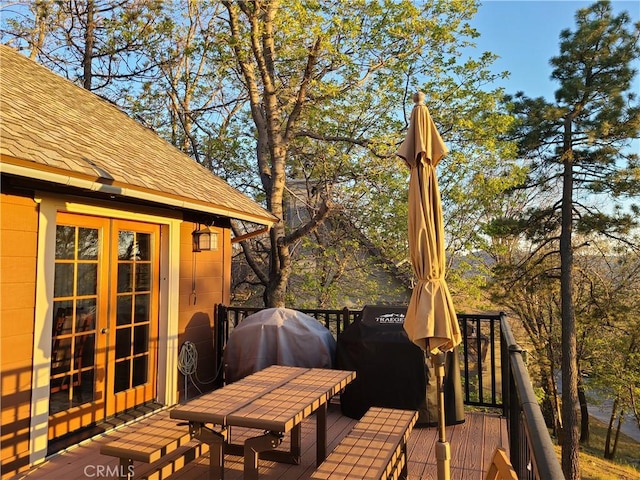 deck featuring french doors and a grill
