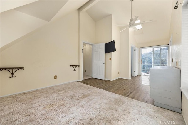 14521 Voltaire Dr, Pine Mountain Club, CA 93222 - unfurnished living room with high vaulted ceiling, a ceiling fan, carpet floors, baseboards, and wood finished floors
