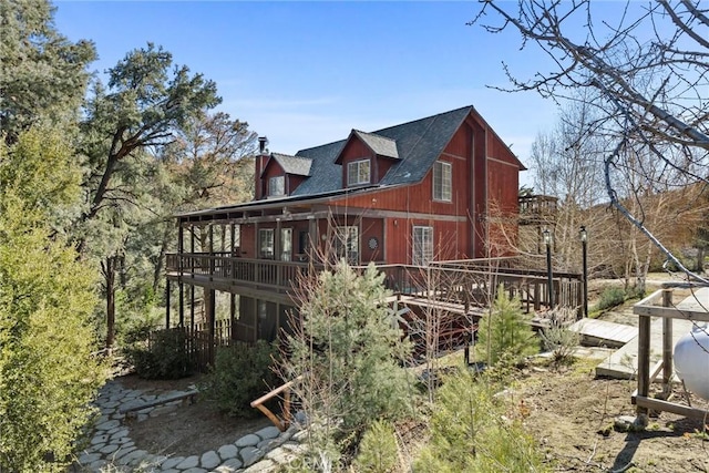 14521 Voltaire Dr, Pine Mountain Club, CA 93222 - view of side of home with a deck, a shingled roof, and a chimney