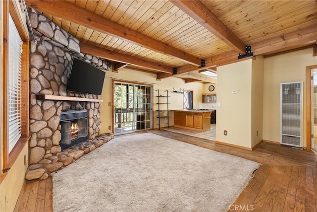 14521 Voltaire Dr, Pine Mountain Club, CA 93222 - unfurnished living room with a heating unit, hardwood / wood-style flooring, a fireplace, wood ceiling with exposed beams, and baseboards