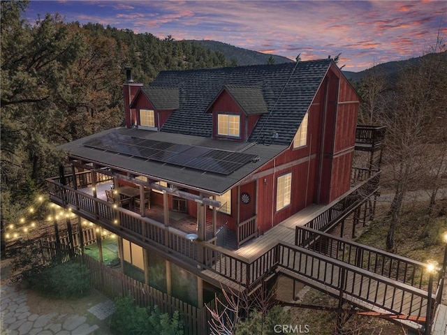 14521 Voltaire Dr, Pine Mountain Club, CA 93222 - rear view of house featuring stairway, a shingled roof, a deck with mountain view, and a chimney