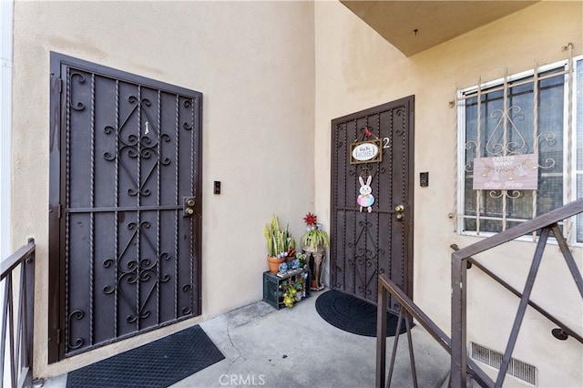 doorway to property with stucco siding