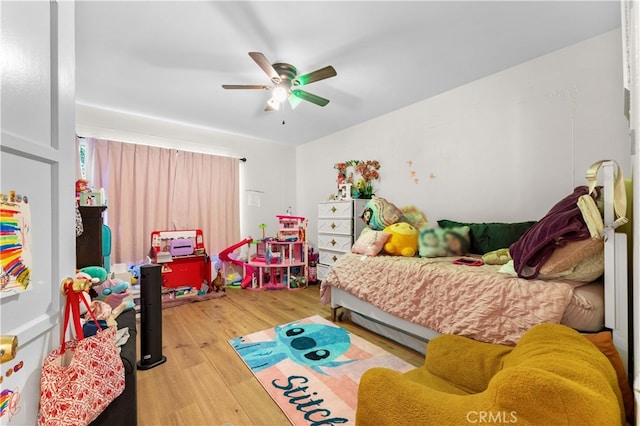 bedroom featuring light wood-style flooring and ceiling fan