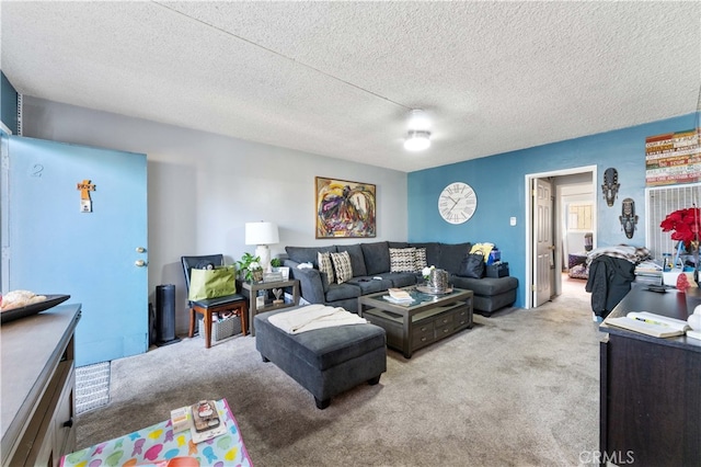 carpeted living room featuring a textured ceiling