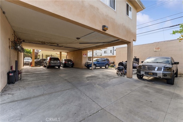 view of parking / parking lot with fence