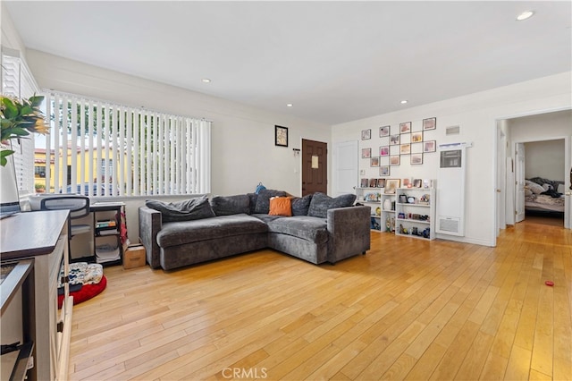 living area featuring light wood-style flooring, recessed lighting, and a wealth of natural light