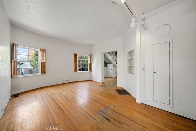1811 Chorro St, San Luis Obispo, CA 93401 - unfurnished living room featuring visible vents, light wood-type flooring, and stairway