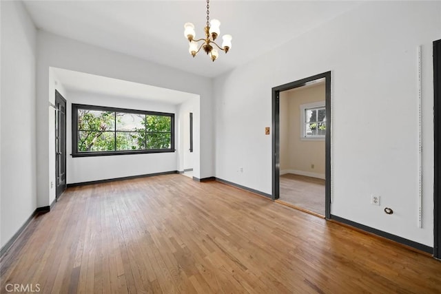 1811 Chorro St, San Luis Obispo, CA 93401 - unfurnished room featuring a wealth of natural light, a notable chandelier, baseboards, and light wood-style flooring