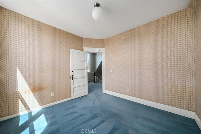1811 Chorro St, San Luis Obispo, CA 93401 - spare room with wallpapered walls, baseboards, and dark carpet