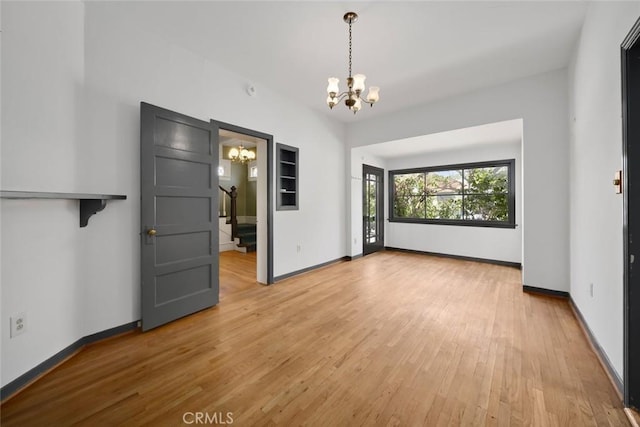 1811 Chorro St, San Luis Obispo, CA 93401 - unfurnished dining area with baseboards, light wood finished floors, an inviting chandelier, and stairs