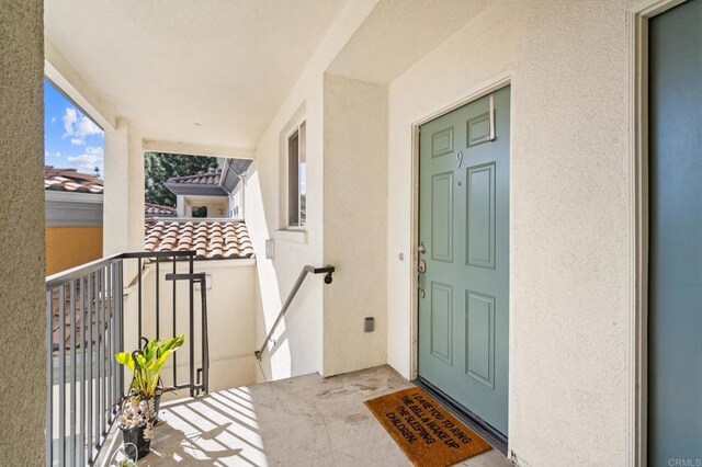 13280 Via Milazzo Unit 9, San Diego, CA 92129 - view of exterior entry featuring stucco siding and a balcony