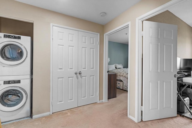 13280 Via Milazzo Unit 9, San Diego, CA 92129 - laundry area with stacked washer / drying machine and light colored carpet