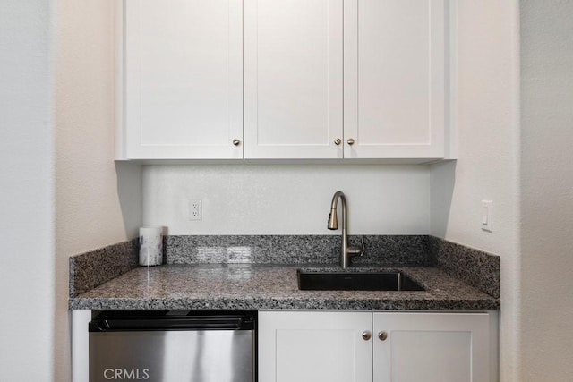 16540 Wyndham Ln Unit 10, Fontana, CA 92336 - kitchen with stainless steel dishwasher, white cabinetry, a sink, and dark stone countertops