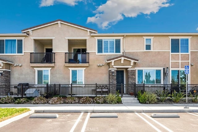 16540 Wyndham Ln Unit 10, Fontana, CA 92336 - view of building exterior with uncovered parking