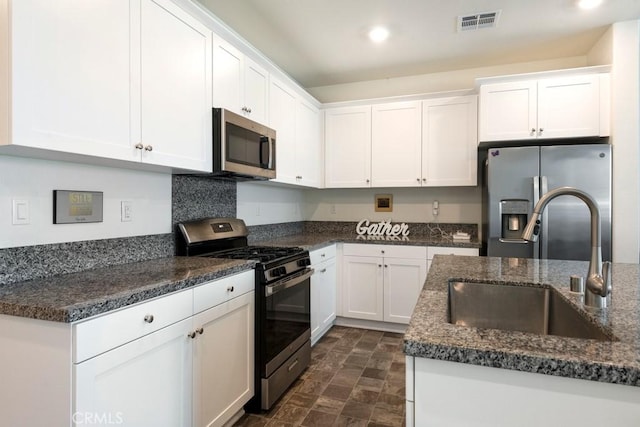 16540 Wyndham Ln Unit 10, Fontana, CA 92336 - kitchen with appliances with stainless steel finishes, a sink, white cabinets, stone finish flooring, and recessed lighting