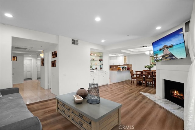 5224 Zelzah Ave Unit 108, Encino, CA 91316 - living room featuring a fireplace with flush hearth, light wood-type flooring, visible vents, and recessed lighting