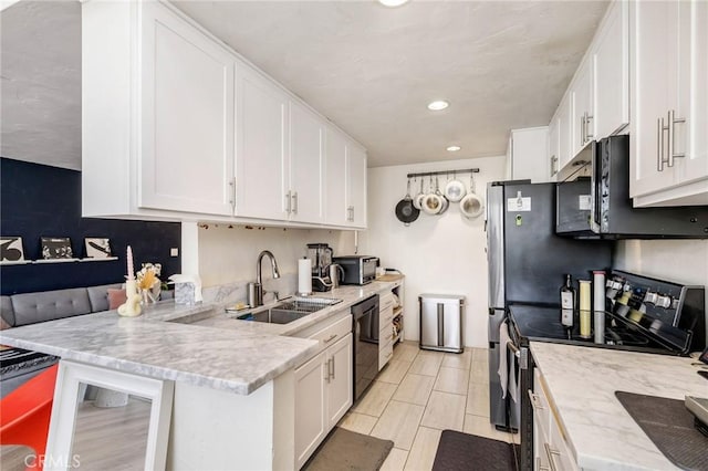 kitchen with white cabinets, black dishwasher, a sink, a peninsula, and stainless steel range with electric cooktop