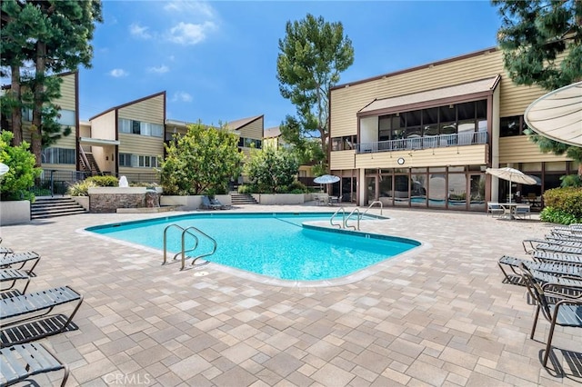 community pool with a patio area