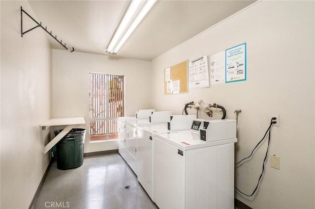 shared laundry area with baseboards and washer and clothes dryer