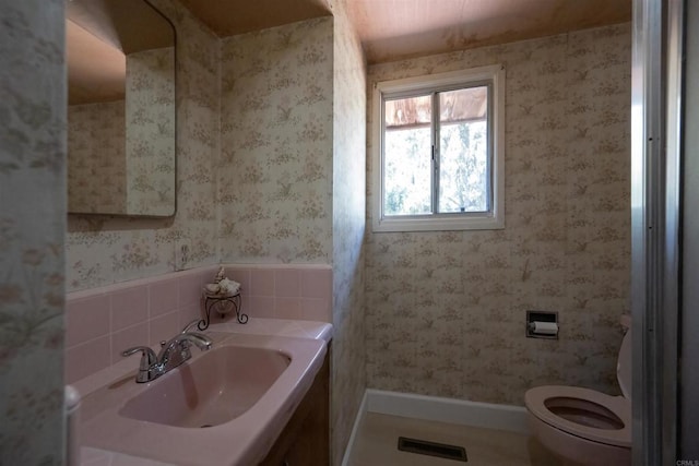 bathroom featuring wallpapered walls, visible vents, vanity, and toilet