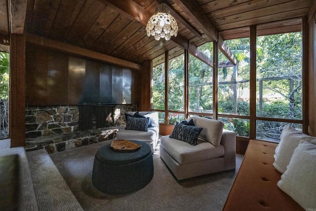 sunroom featuring beam ceiling and a healthy amount of sunlight