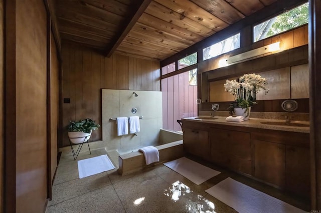 bathroom with a bathtub, wood walls, wooden ceiling, and a sink