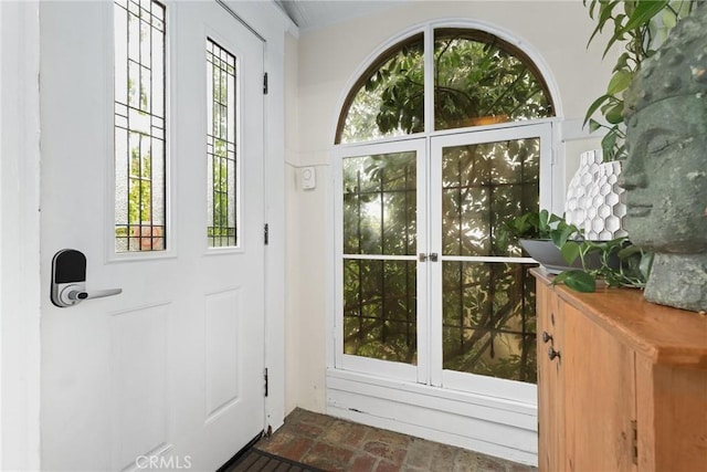 doorway with brick floor and a healthy amount of sunlight
