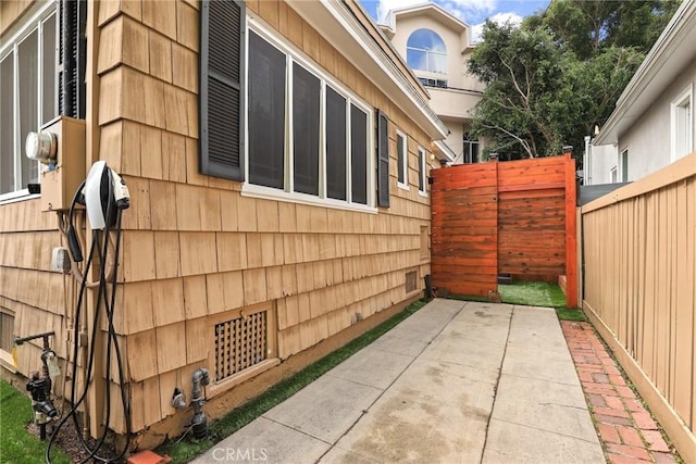 view of side of property featuring fence and a patio area