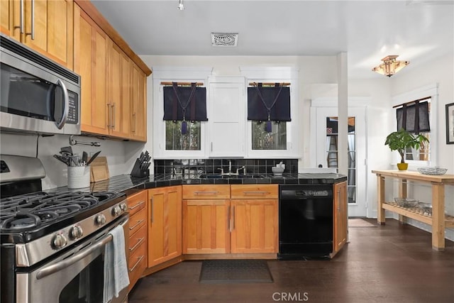 kitchen with visible vents, appliances with stainless steel finishes, tile countertops, and decorative backsplash
