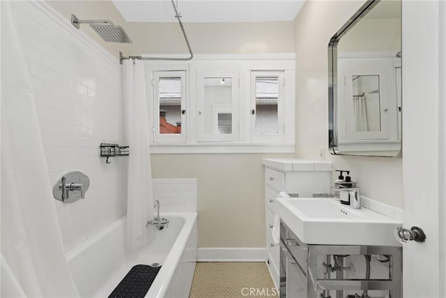 full bath featuring baseboards, shower / bath combo, and tile patterned floors