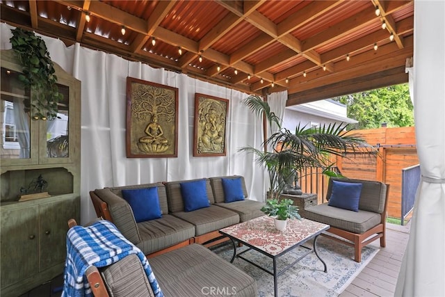 sunroom featuring beam ceiling