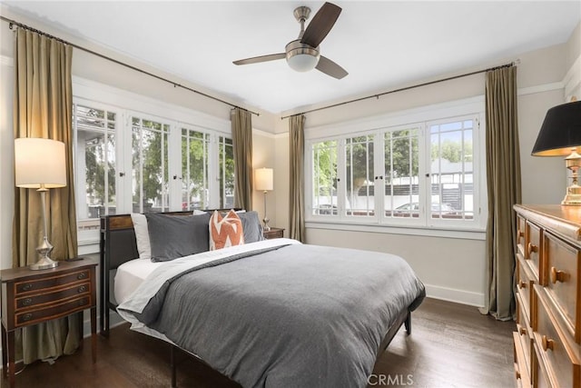 bedroom with ceiling fan, baseboards, french doors, and dark wood finished floors