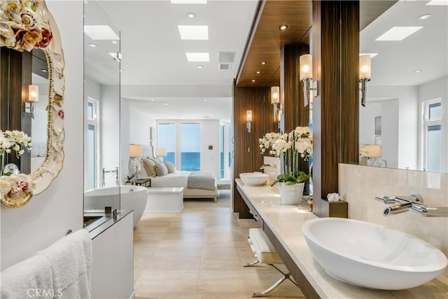 31091 Coast Hwy, Laguna Beach, CA 92651 - full bathroom featuring a freestanding tub, double vanity, recessed lighting, a skylight, and a sink