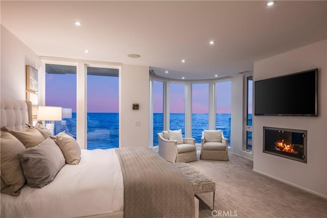 31091 Coast Hwy, Laguna Beach, CA 92651 - carpeted bedroom with a glass covered fireplace, recessed lighting, and expansive windows