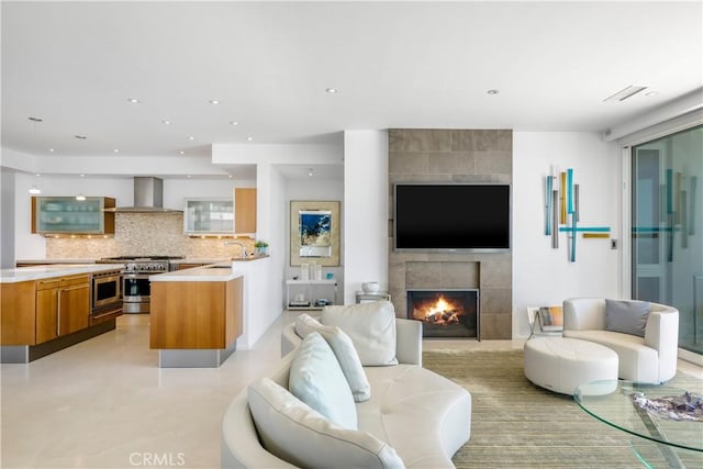 31091 Coast Hwy, Laguna Beach, CA 92651 - living room featuring concrete floors, recessed lighting, and a tile fireplace