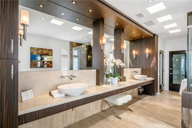 31091 Coast Hwy, Laguna Beach, CA 92651 - full bathroom featuring visible vents, a sink, a skylight, and decorative backsplash