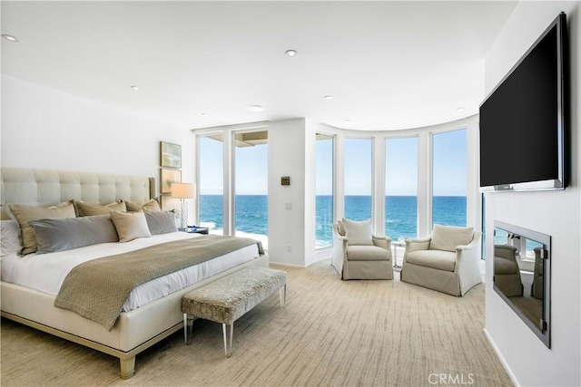 31091 Coast Hwy, Laguna Beach, CA 92651 - bedroom featuring baseboards, floor to ceiling windows, access to outside, a glass covered fireplace, and light carpet