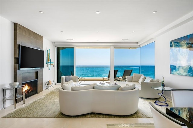 31091 Coast Hwy, Laguna Beach, CA 92651 - living room featuring a tiled fireplace, recessed lighting, and a water view