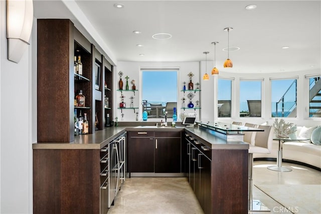 31091 Coast Hwy, Laguna Beach, CA 92651 - kitchen with pendant lighting, dark brown cabinets, open shelves, recessed lighting, and a sink