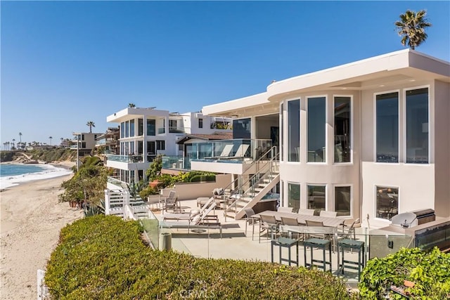 31091 Coast Hwy, Laguna Beach, CA 92651 - exterior space featuring a patio area, a water view, area for grilling, stairs, and a view of the beach